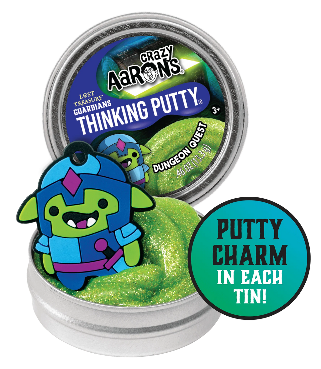 Open small tin with green putty and a charm of a small cartoon style knight.