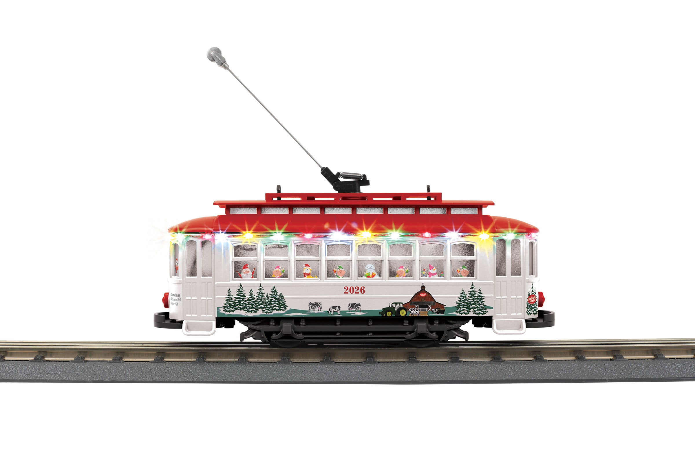 Model of a trolley with painted white and red with a winter farm seen on the sides.