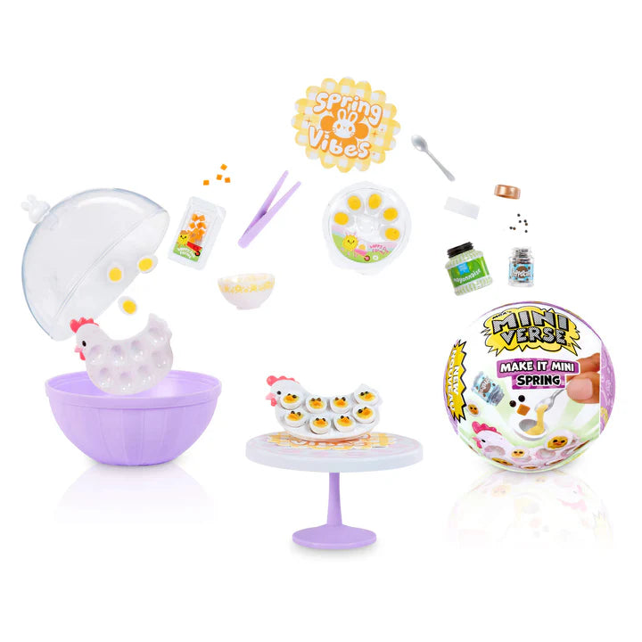 Miniature craft kit with supplies and a miniature chicken tray with devilled eggs on a table.