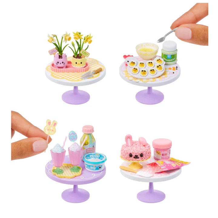 Set of spring themed miniature tables with food items and a hand interacting with them.