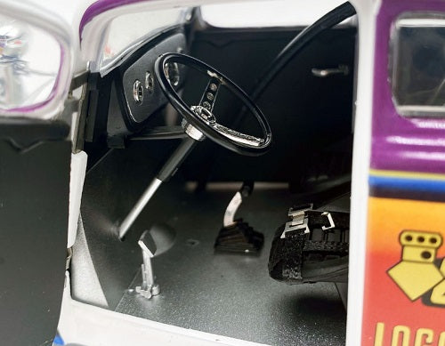 Model car interior with steering wheel and dashboard.