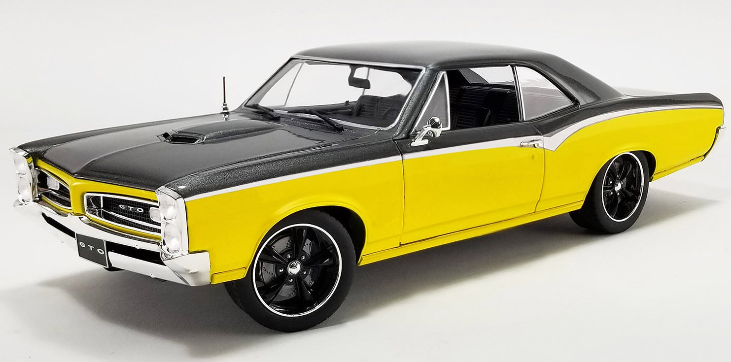 A 1/18 scale model of a 1966 Pontiac GTO Restomod in yellow and black colors.