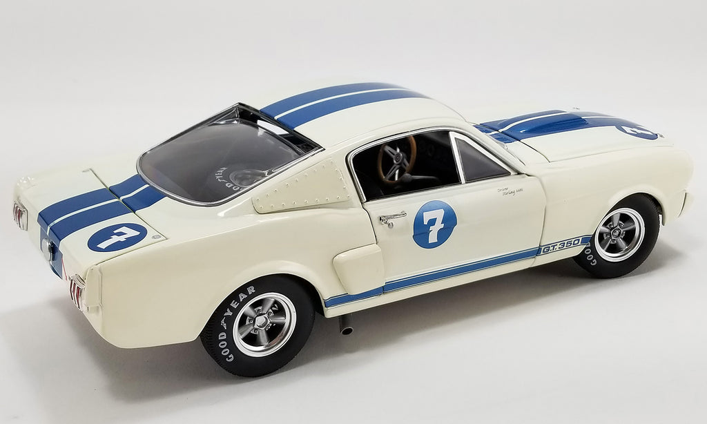 A 1/18 scale model of a 1966 Ford Shelby GT350 - #7 Stirling Moss in blue and white with vintage racing graphics.