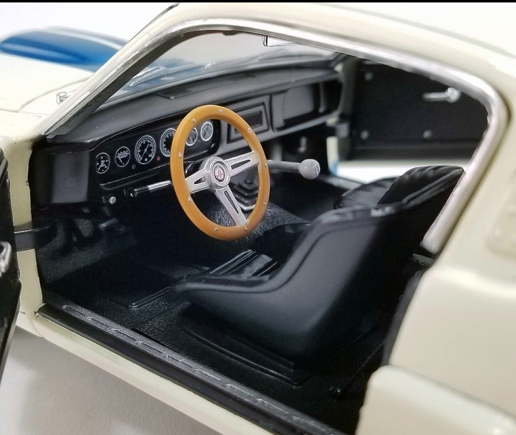 Interior view of diecast model car showing dashboard and steering wheel.