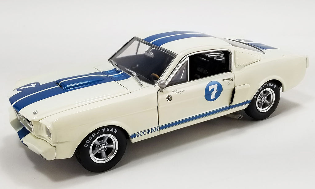 A 1/18 scale model of a 1966 Ford Shelby GT350 - #7 Stirling Moss in blue and white with vintage racing graphics.