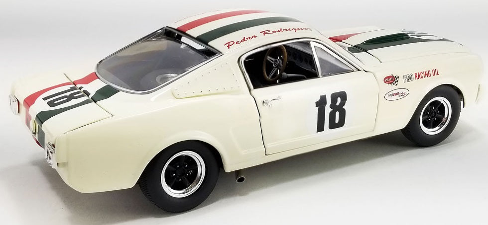 A 1/18 scale diecast model of a 1965 Shelby GT350R race car in white with red and black with the number 18.