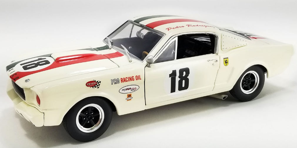 A 1/18 scale diecast model of a 1965 Shelby GT350R race car in white with red and black with the number 18.