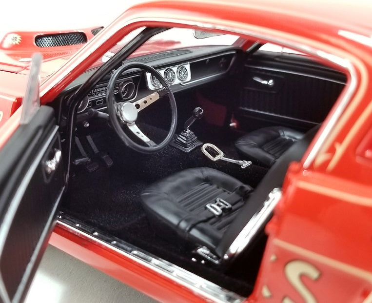 Interior view of drivers side seat, steering wheel, and dashboard.