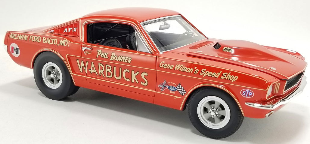 Front and side view of red car with writing on it.