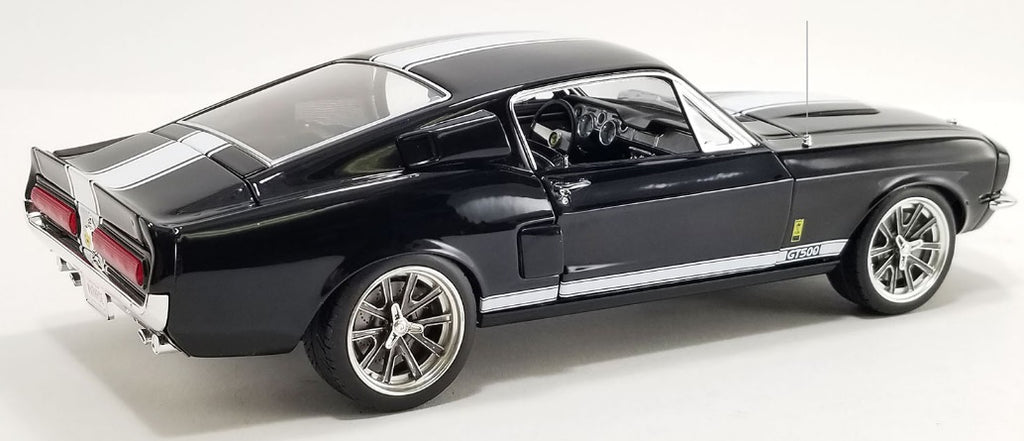 A 1/18 scale model of a 1968 Shelby GT500 Restomod War Horse with a black exterior and white stripes.