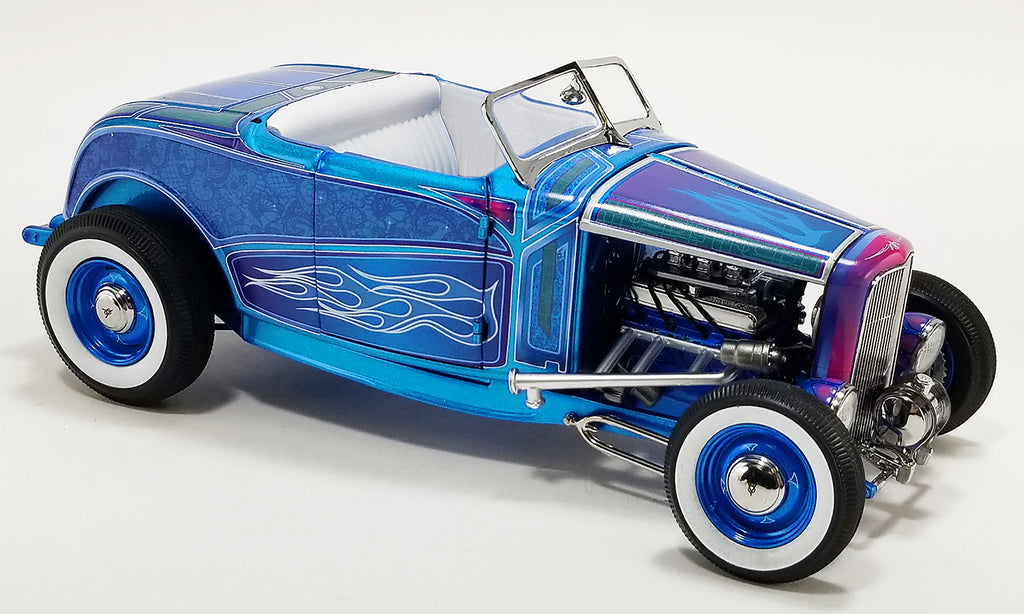 A 1/18 scale model of a 1932 Ford Hot Rod Roadster in blue flame color with white wall tires and blue steelie wheels.