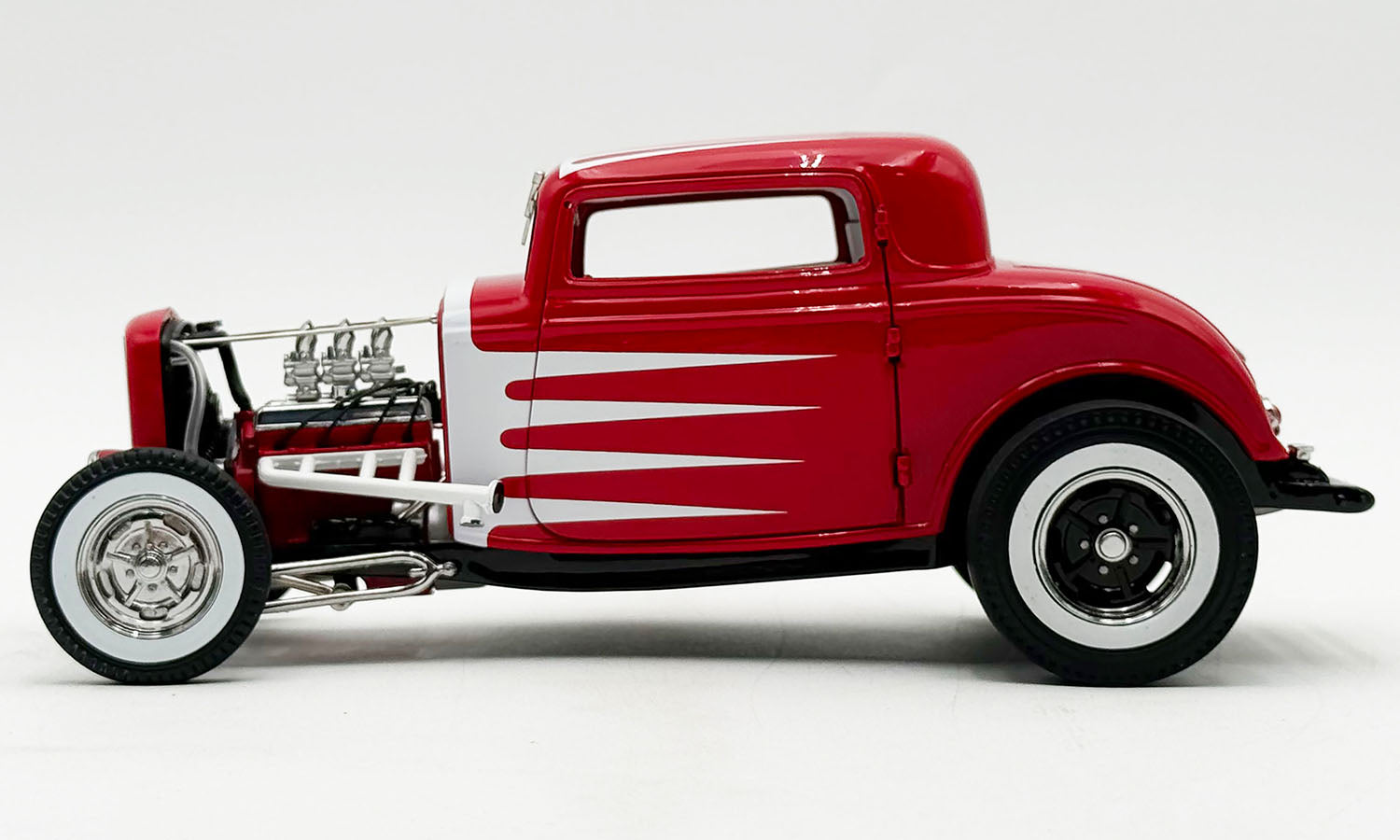 Model of red and White 3 window coupe.