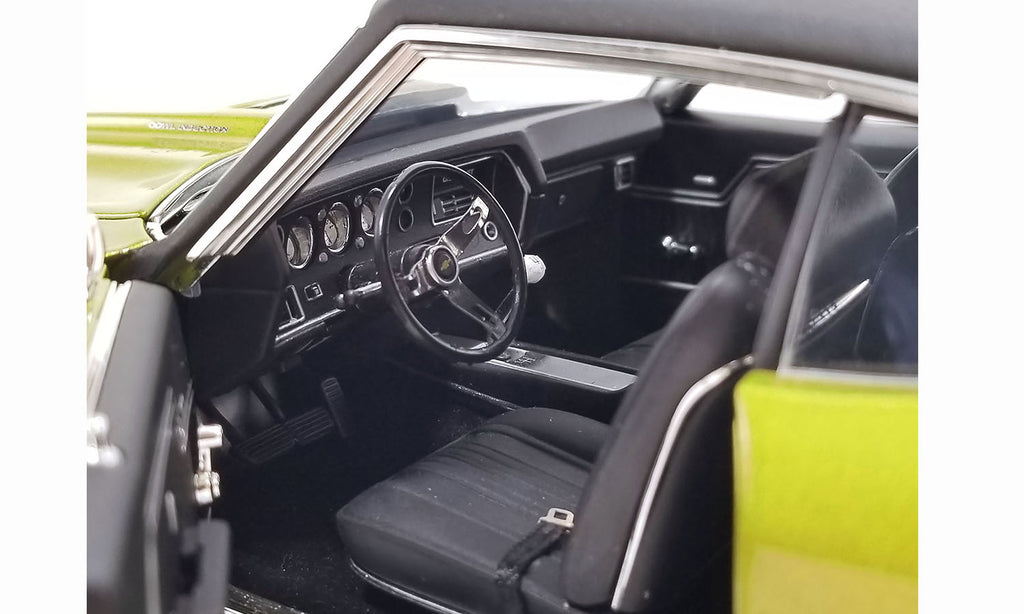 Interior view of steering wheel and dashboard in a diecast model car.