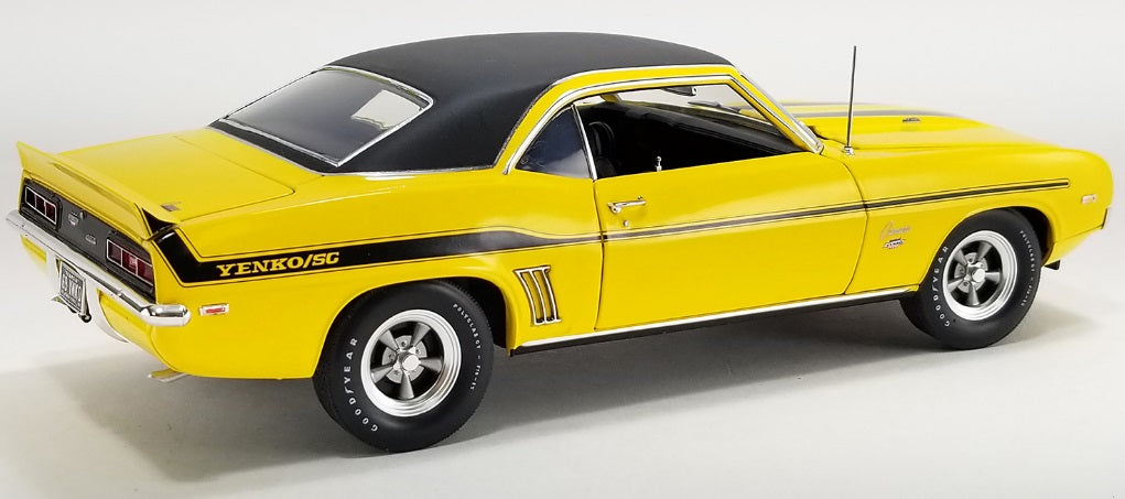 1/18 scale diecast model car of Yellow Camaro car with black roof.