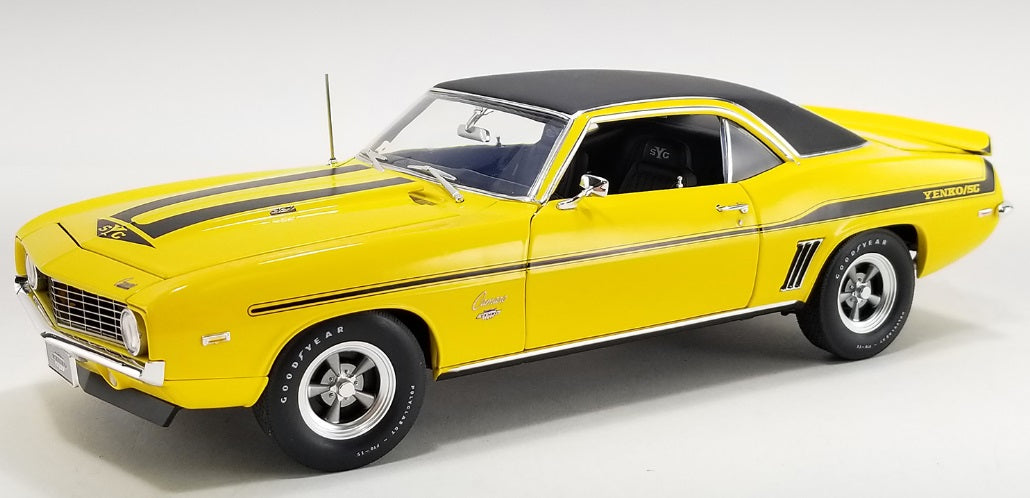 1/18 scale diecast model car of Yellow Camaro car with black roof.