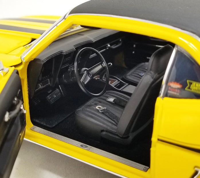 Interior photo of drivers side, steering wheel, driver's seat, and dashboard.