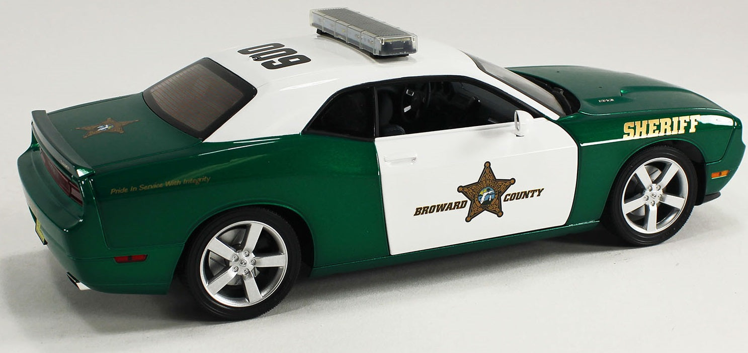 1/18 scale model of a Dodge Challenger R/T police car in green and white with a 'Broward County Sheriff' design. 