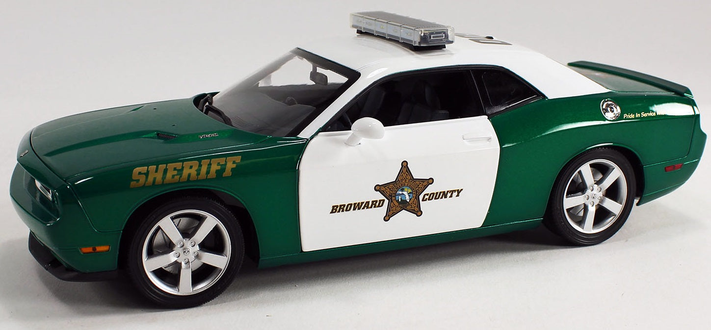 1/18 scale model of a Dodge Challenger R/T police car in green and white with a 'Broward County Sheriff' design. 