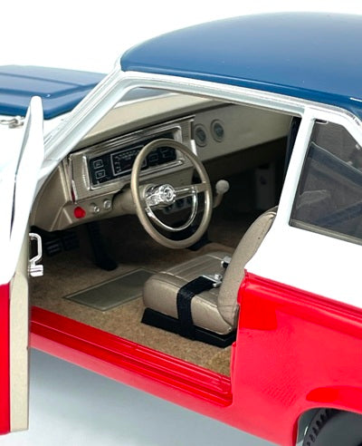 An interior view 1/18 scale model of a 1965 Plymouth AWB Sox & Martin racing car with a red, white, and blue paint scheme.
