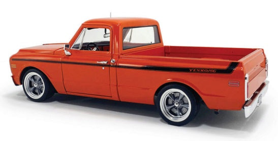 Side view of orange pick up truck with thin black stripe.