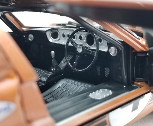 Close-up of a classic car's interior with steering wheel and dashboard.