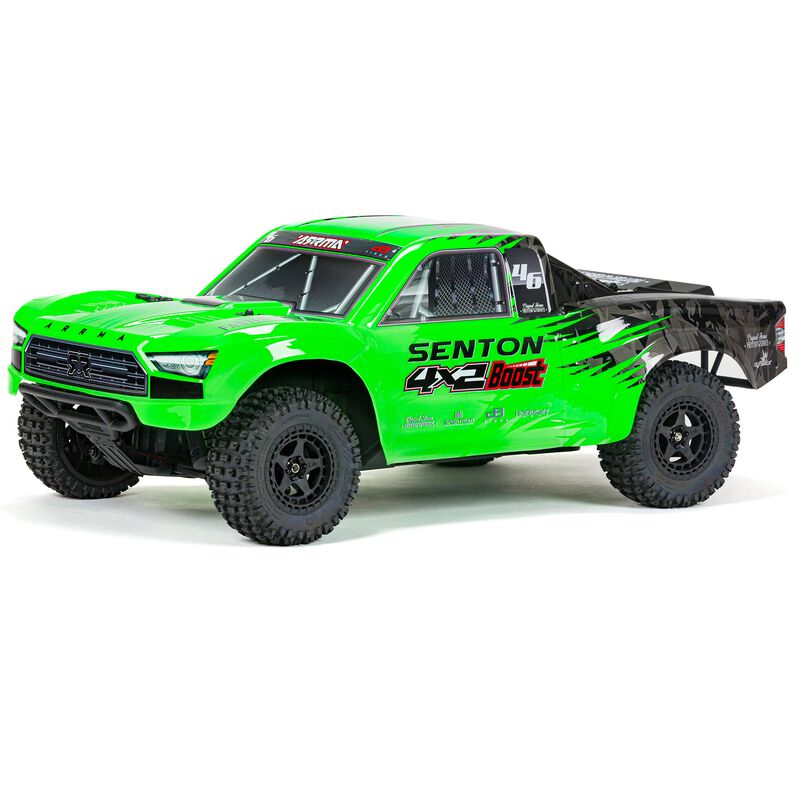 Side view of green short course truck.