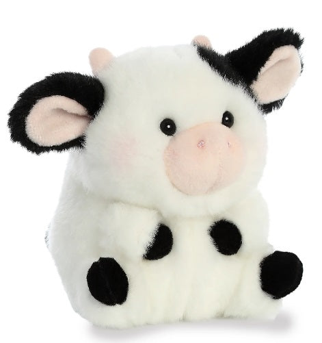 Small plush cow sitting in a rolled up position.