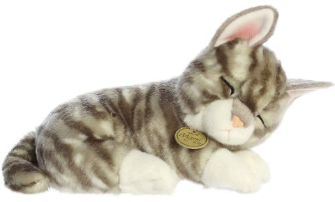 Plush toy of a sleeping gray cat with stripes and white pawsl.