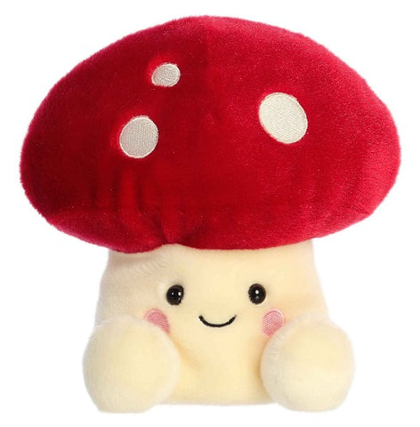 Plush mushroom with red top and white spots, trunk of mushroom has a smiling face.