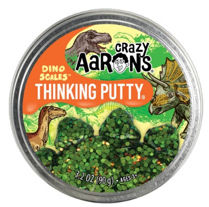 Round metal tin with dinosaur pictures and  putty with green round speks in it.