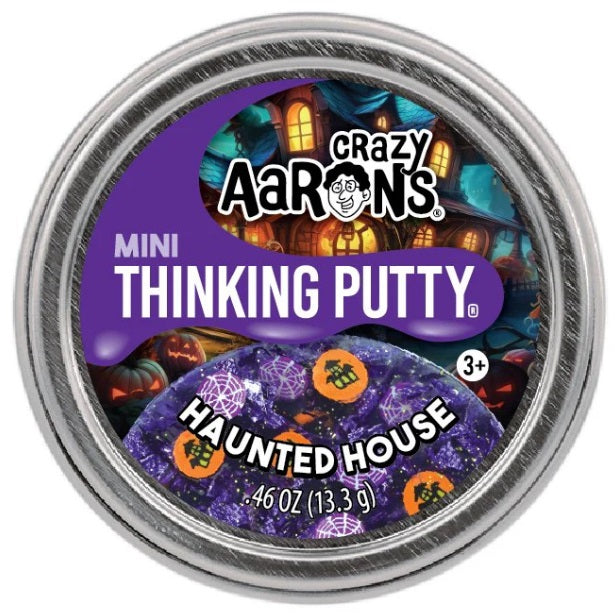 Round metal tin of purple putty with spider web and haunted house themed pieces.