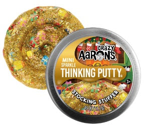Round metal tin of gold putty with colorful shapes mixed in.