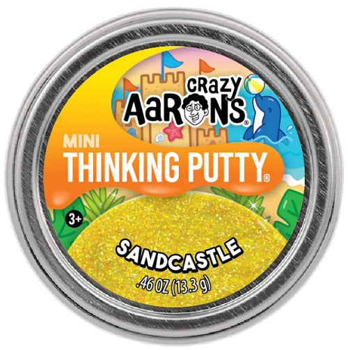 Round metal container with a picture of sparkly yellow putty, a sand castle, and a dolphin.