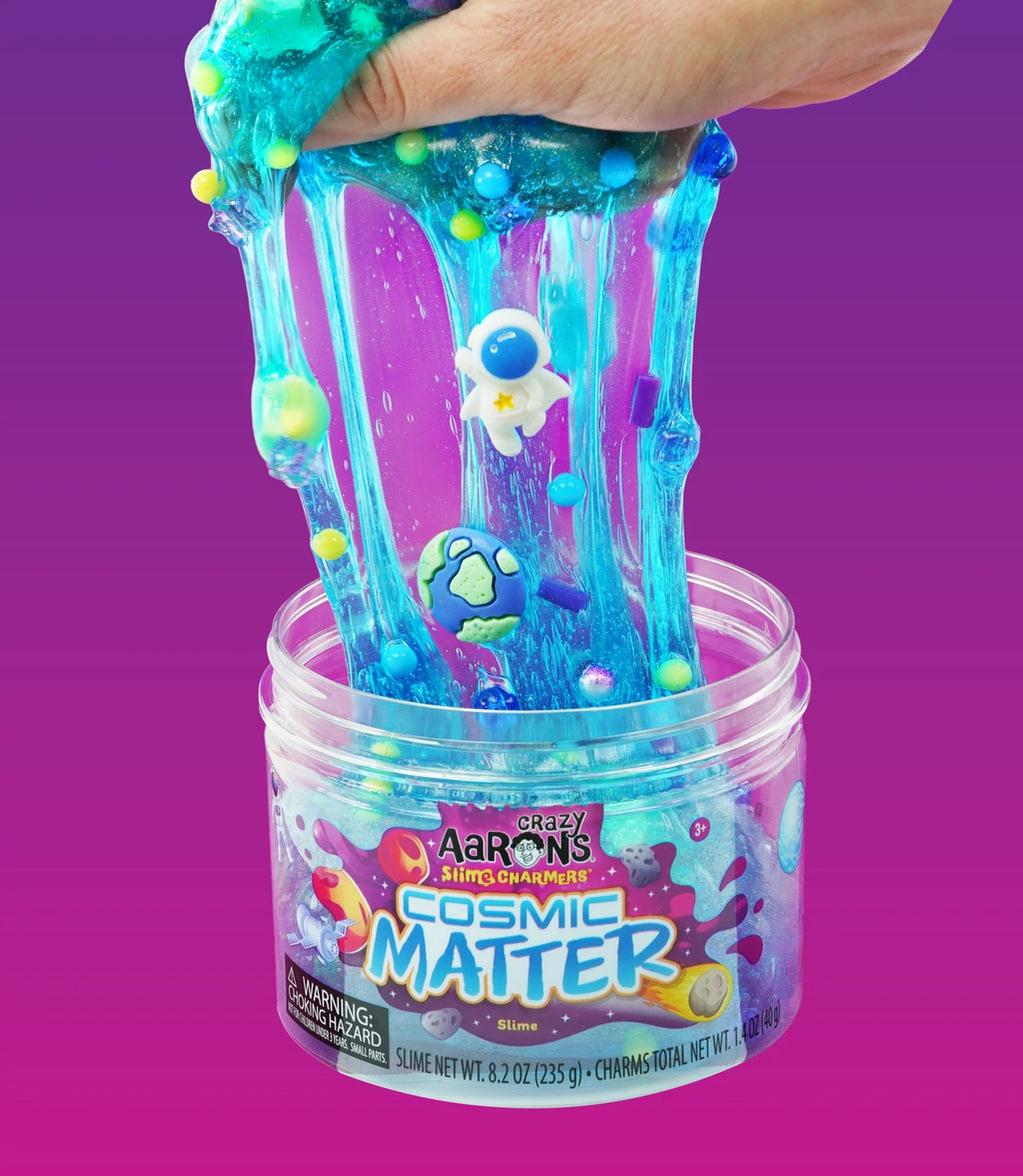 Blue slime with shaped charms being pulled from jar.