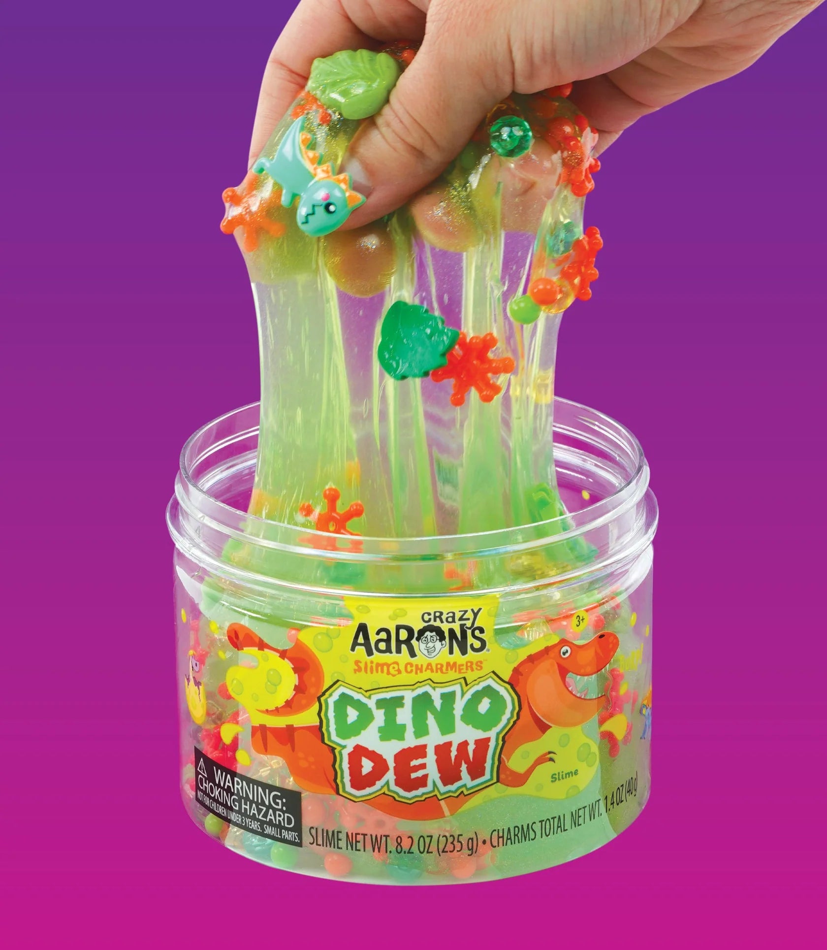 Green slime with shaped charms stretching out of container.