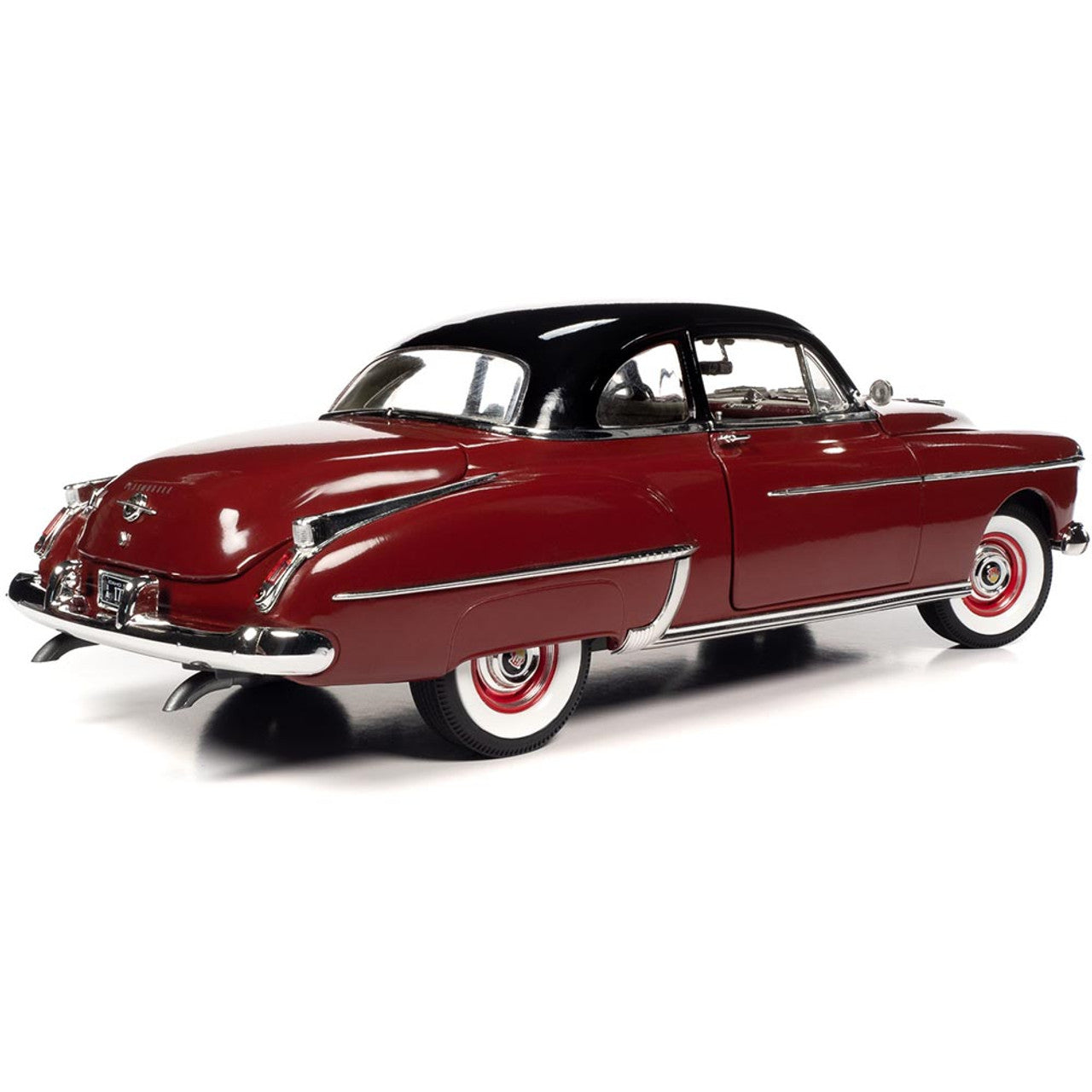 A diecast model of a red 1950 Oldsmobile Rocket 88.