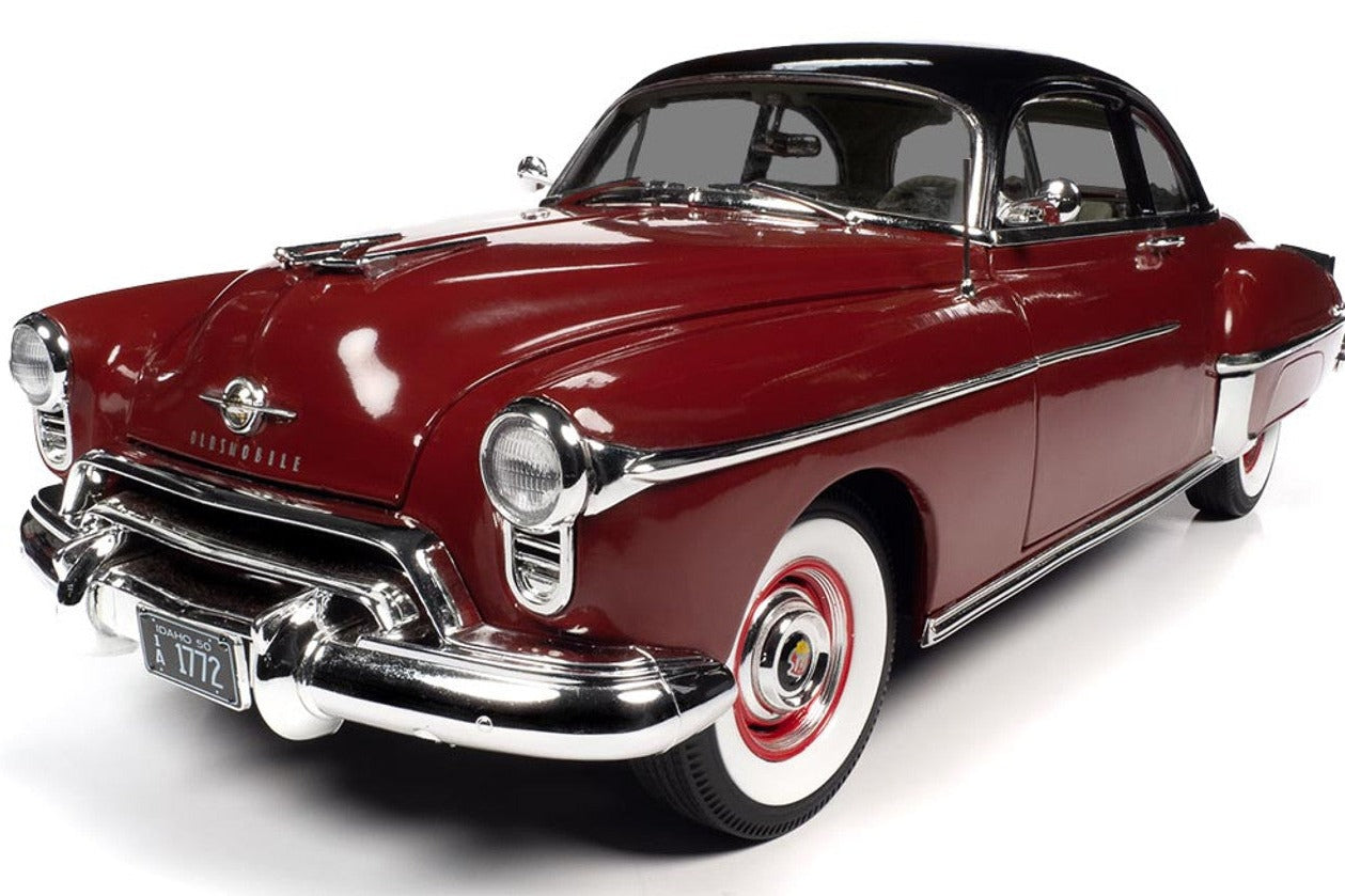 A diecast model of a red 1950 Oldsmobile Rocket 88.