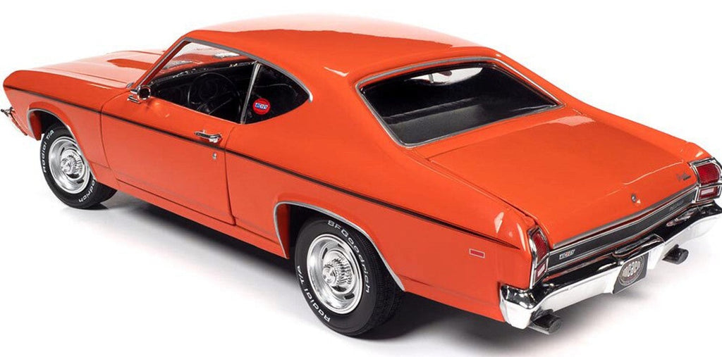A 1/18 scale model of an orange 1969 Chevy Chevelle COPO  with a black stripe on the side.