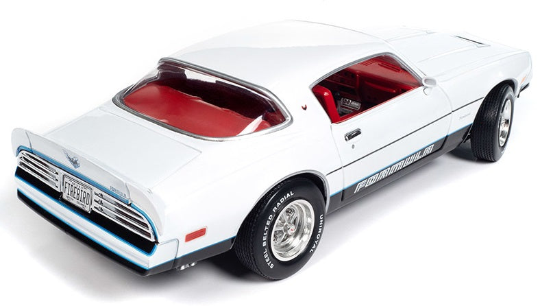 A 1/18 scale diecast model of a 1977 Pontiac Firebird Formula with a white body, red interior, and black details.