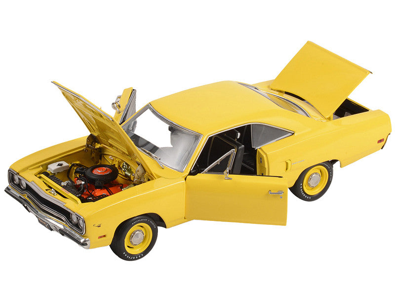 A 1/18 scale diecast model of a 1970 Plymouth Road Runner in yellow lemon twist color with open hood, doors, and trunk.