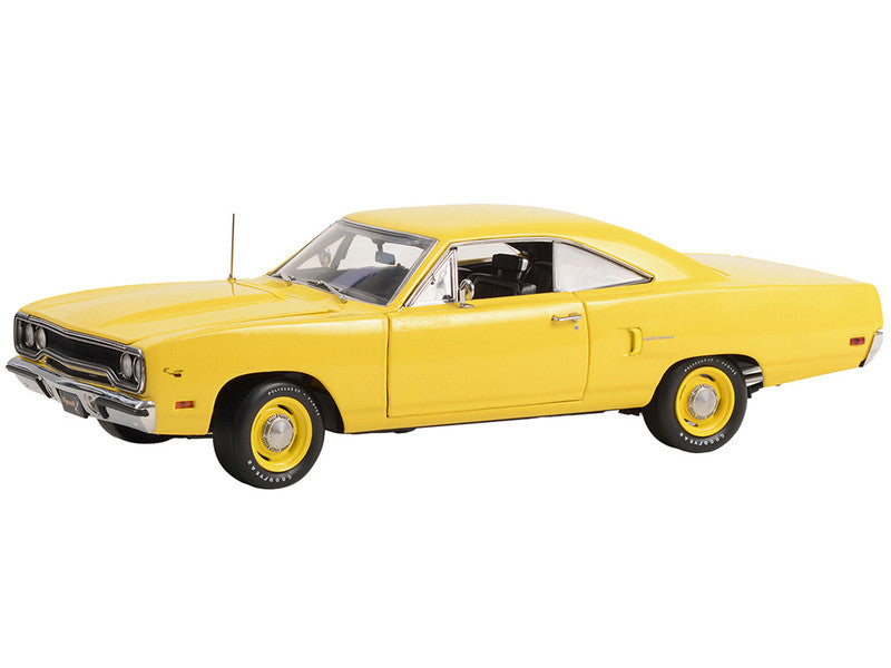 A 1/18 scale diecast model of a 1970 Plymouth Road Runner in yellow lemon twist color, with opening hood, doors, and trunk.