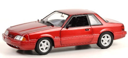 A 1/18 scale diecast model of a red 1993 Ford Mustang LX 5.0.