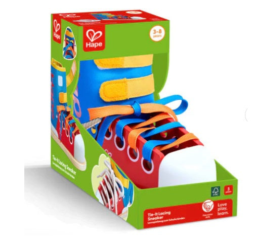 Colorful toy shoe with laces in a Hape packaging on a white background