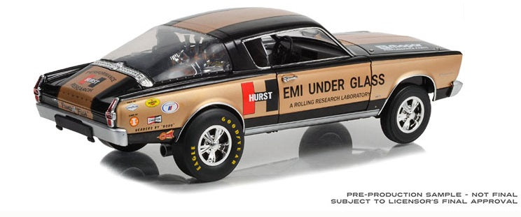 1/18 scale model of a 1966 Plymouth Barracuda Hurst HEMI Under Glass with tan and black coloring and has 'HEMI UNDER GLASS' livery.