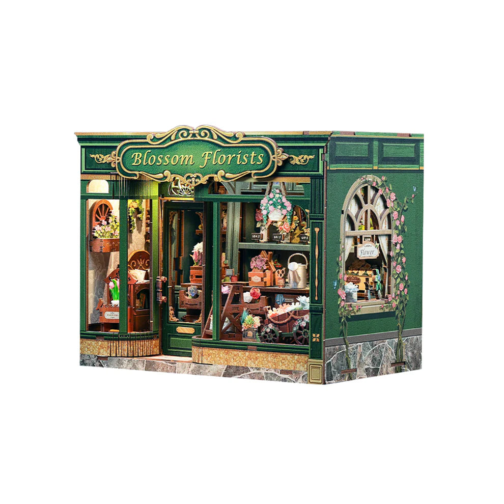 Assembled Book nook kit of a city building with shelves full of flowers.