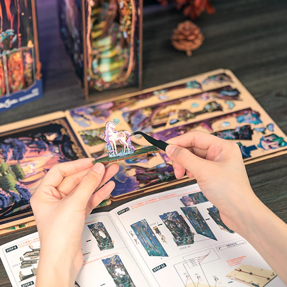 A person assembling pieces of a laser cut kit.