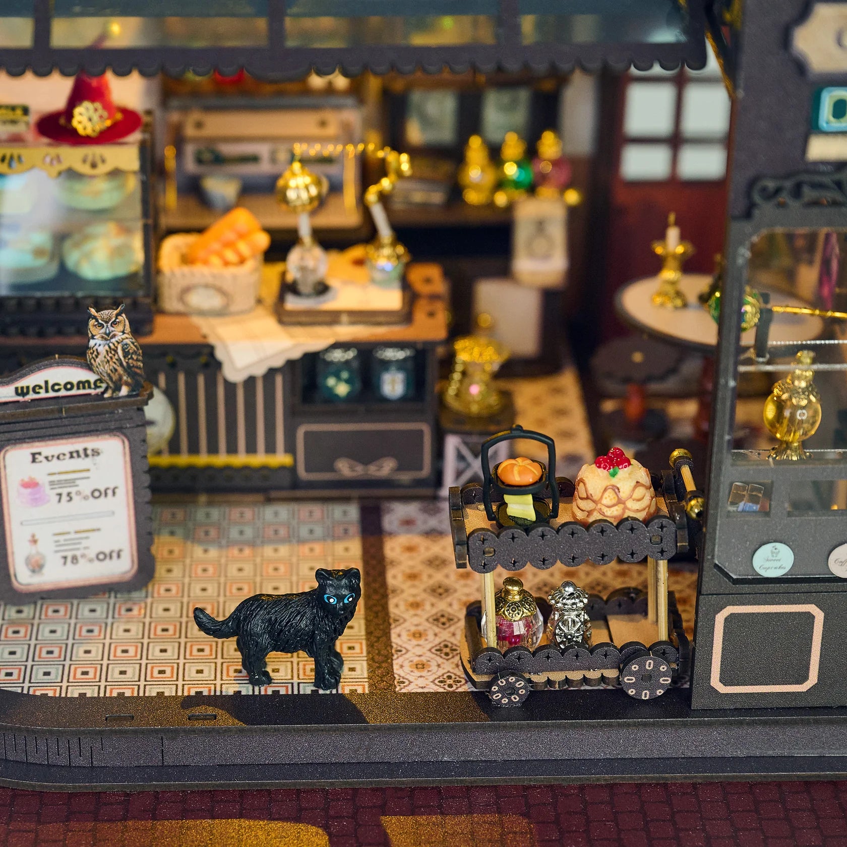 Close up of Magic Cafe kit interior showing a black cat and food cart.