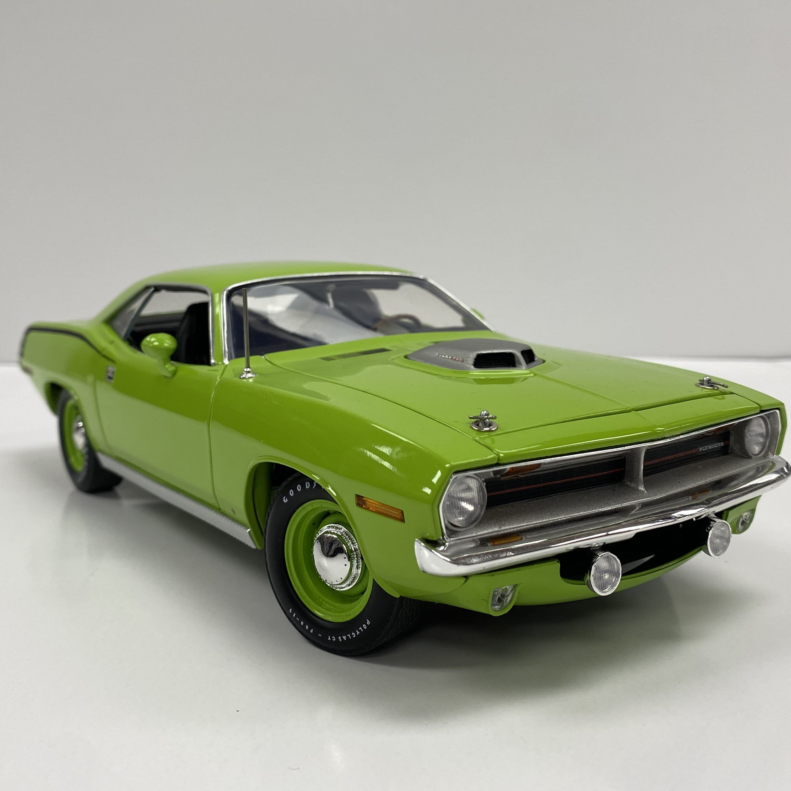 Diecast model of 1970 Plymouth Cuda in lime light green.