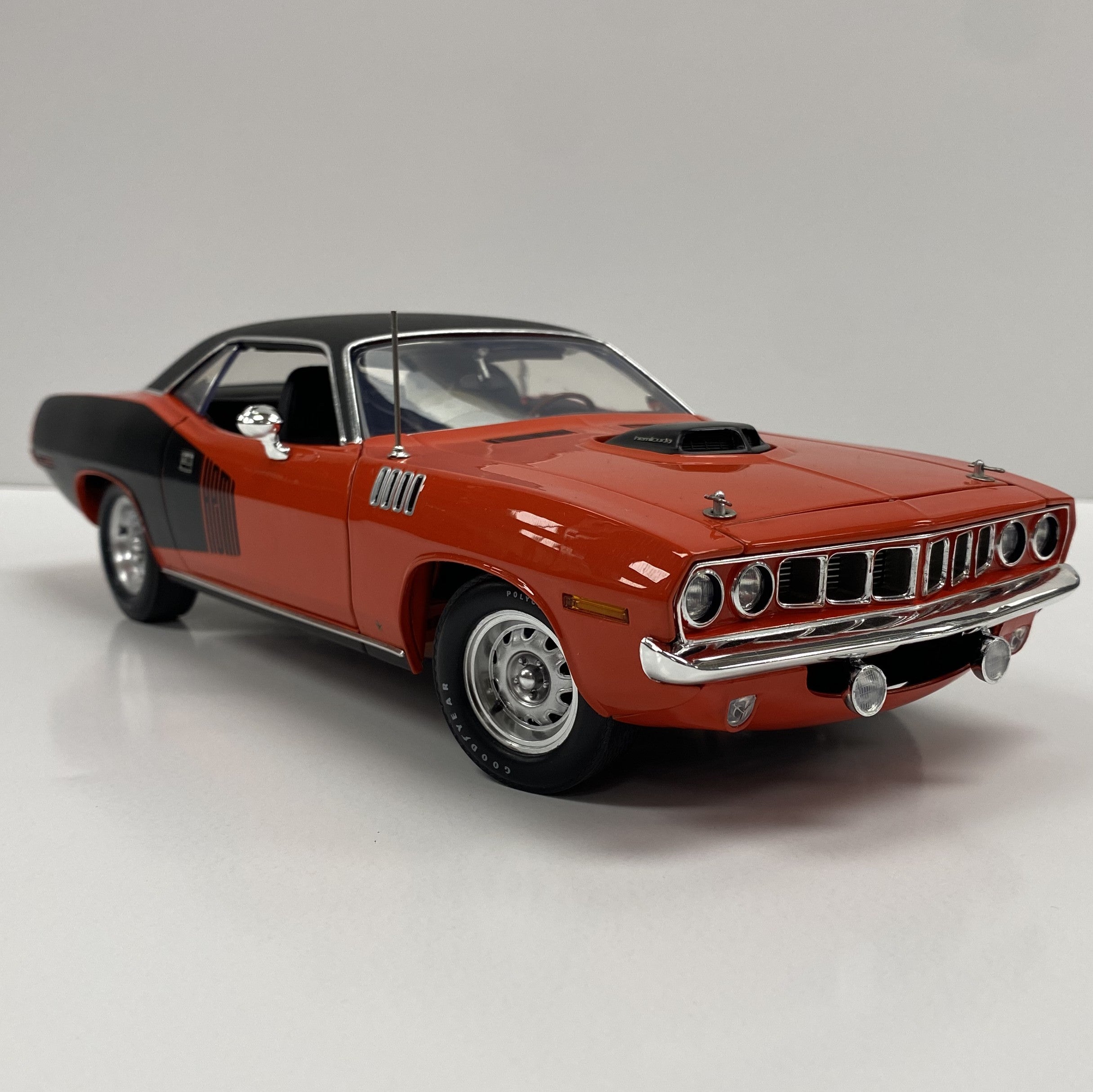 1/18 scale model of 1971 Plymouth Cuda in Red with black top.