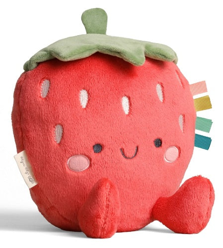 Plush strawberry toy with a smiling face on a white background
